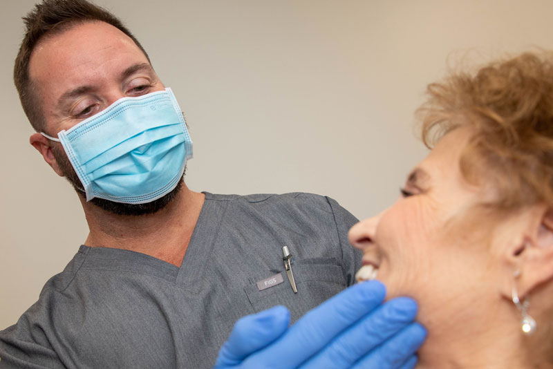 Dr. David A. Bulot Working On A Dental Implant Patient